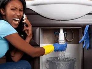 Emergency plumbing repair for a leaking sink drain under a bathroom vanity in Green Bay, WI