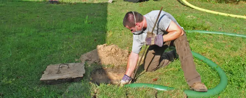 Septic pumping technician servicing a residential septic tank in Green Bay, WI